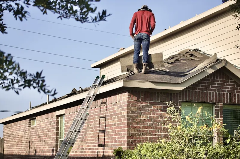 Professional roofer working on a residential roof in Golden